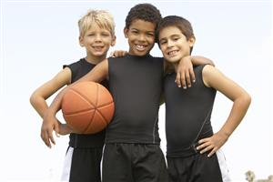 3 Young Boys Holding A Basketball In A Group Hug